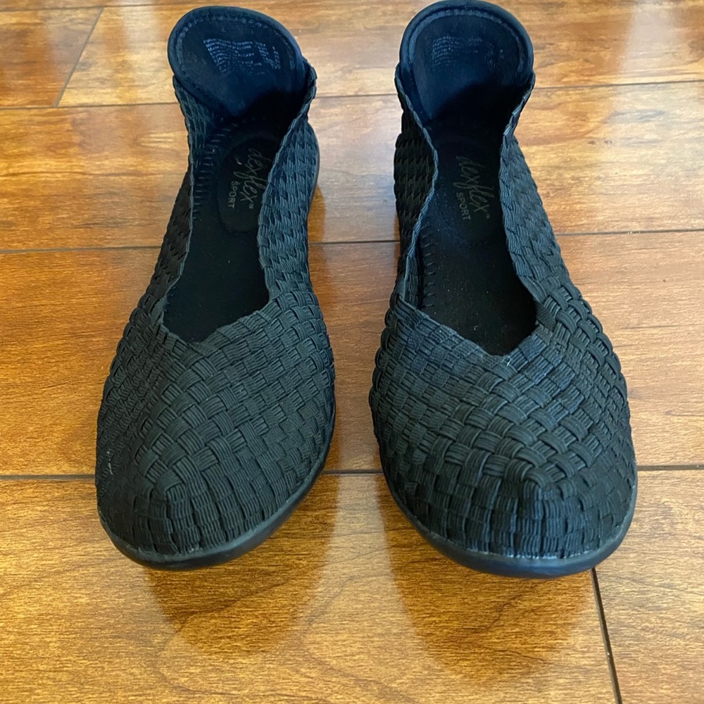 Black flexible flat shoes.